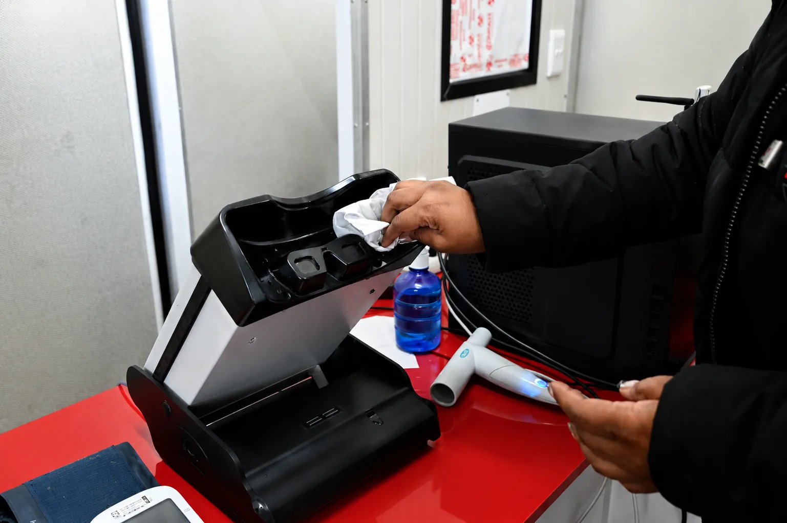 A Care Net clinician sanitising spirometry equipment between medicals.